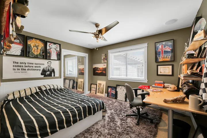 Bedroom featuring a ceiling fan, recessed lighting, and a window with blinds