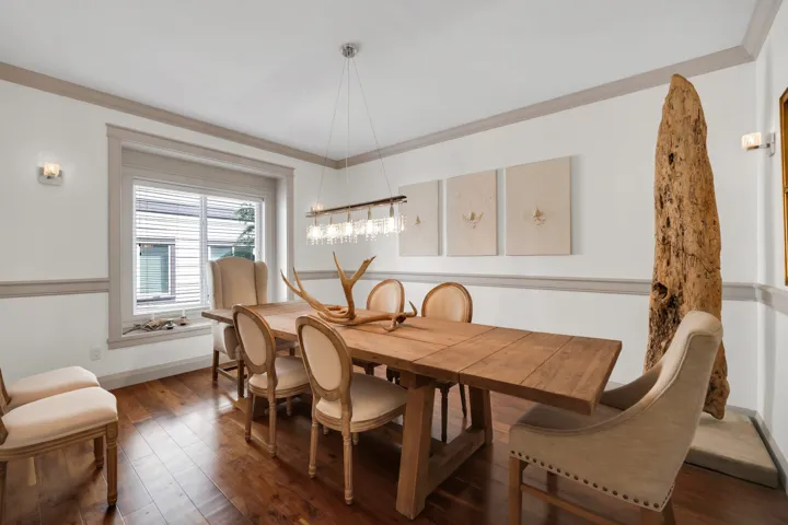 Dining area featuring wood-finish flooring and a large window with blinds