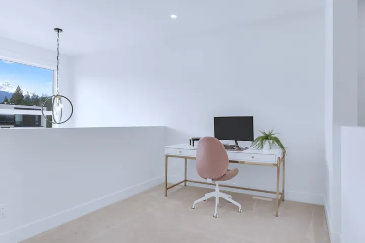 Carpeted home office featuring baseboards