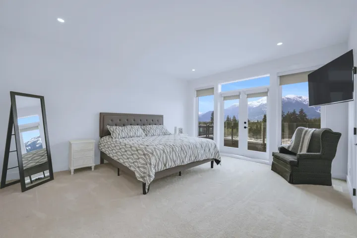 Bedroom with recessed lighting, carpet flooring, multiple windows, and french doors