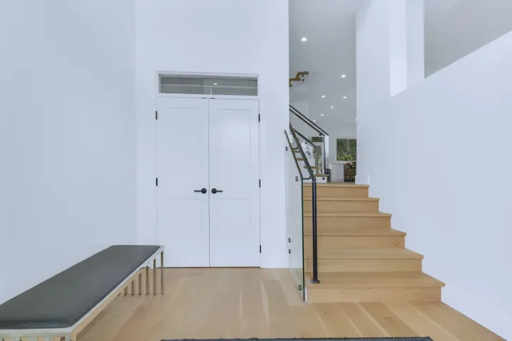 Stairway with baseboards, wood finished floors, and recessed lighting