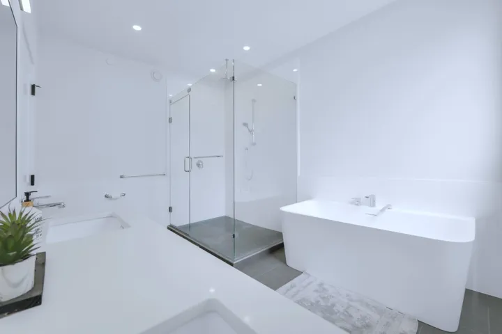 Full bath with a freestanding bath, a shower stall, recessed lighting, and a sink