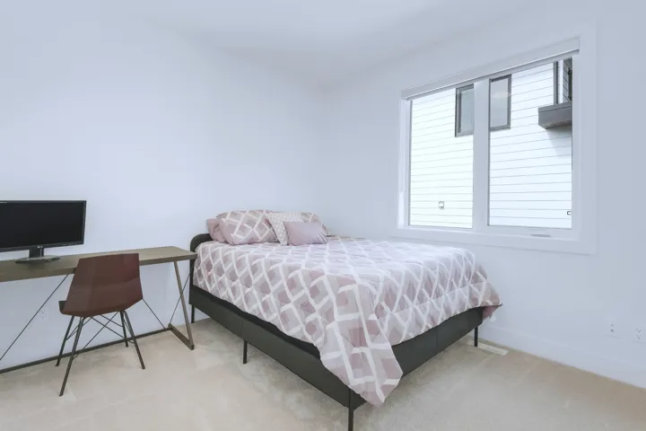 Carpeted bedroom with baseboards