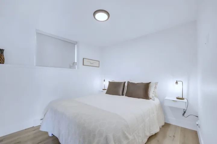 Bedroom featuring wood finished floors and baseboards