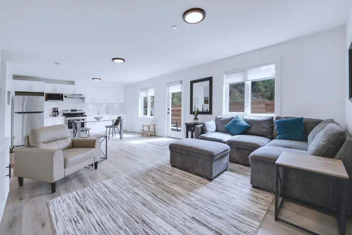 Living room with recessed lighting, light wood-style floors, and a healthy amount of sunlight
