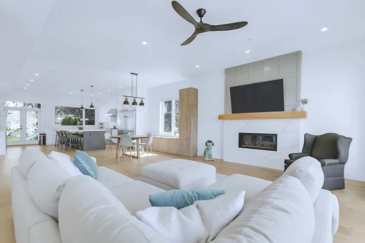 Living room featuring a wealth of natural light, a ceiling fan, recessed lighting, and a fireplace