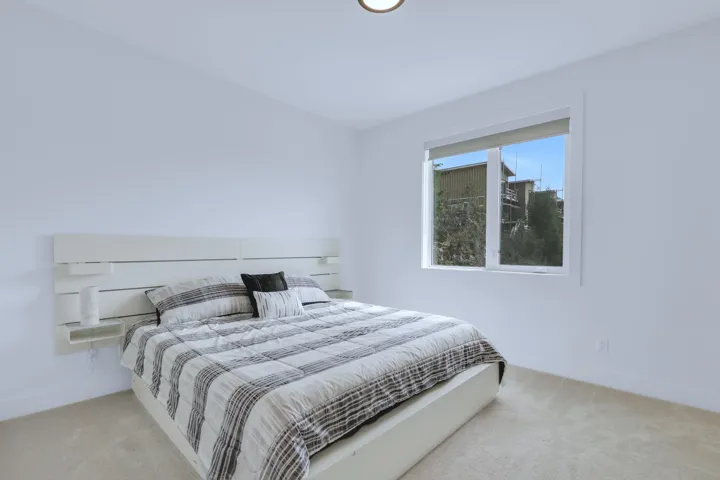 Bedroom featuring baseboards and carpet floors