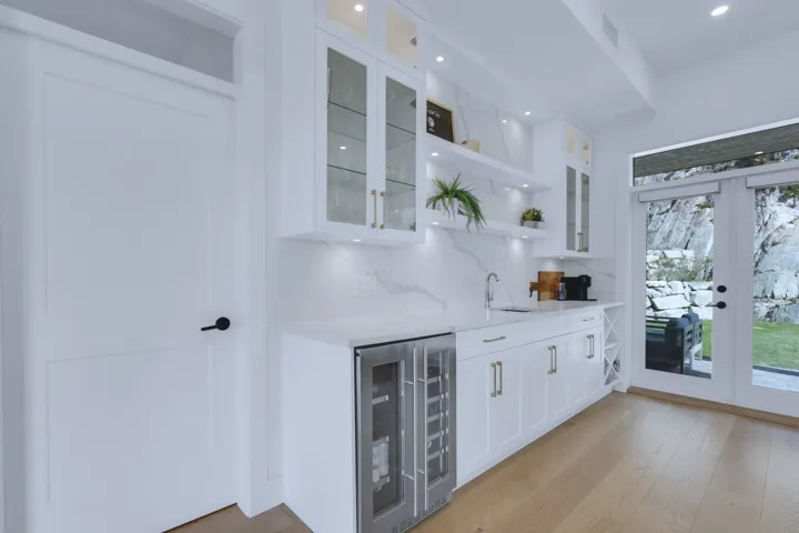 Bar with french doors, wet bar, beverage cooler, and tasteful backsplash