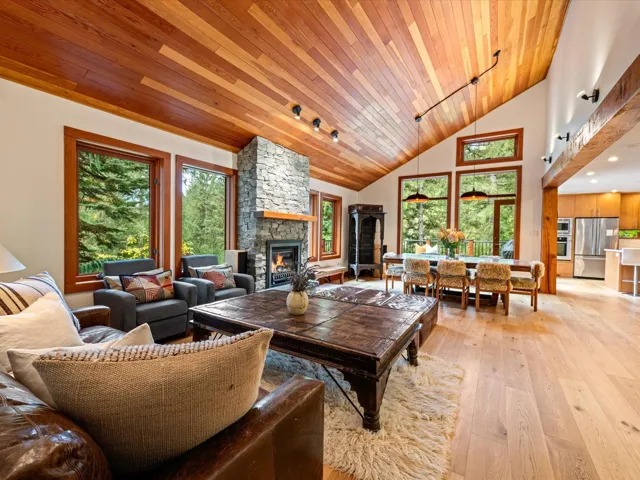 Great room with vaulted wood-plank ceiling and light wood-finish flooring