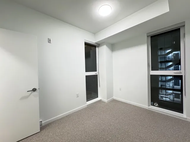 Spare room featuring carpet and baseboards