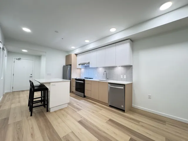 Kitchen featuring white cabinetry, a kitchen bar, electric range, modern cabinets, and recessed lighting