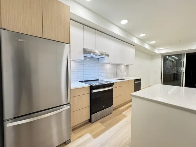 Kitchen with appliances with stainless steel finishes, white cabinets, modern cabinets, and recessed lighting