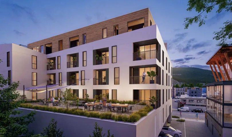 Property at dusk with a view of apartment building / complex and a mountain view