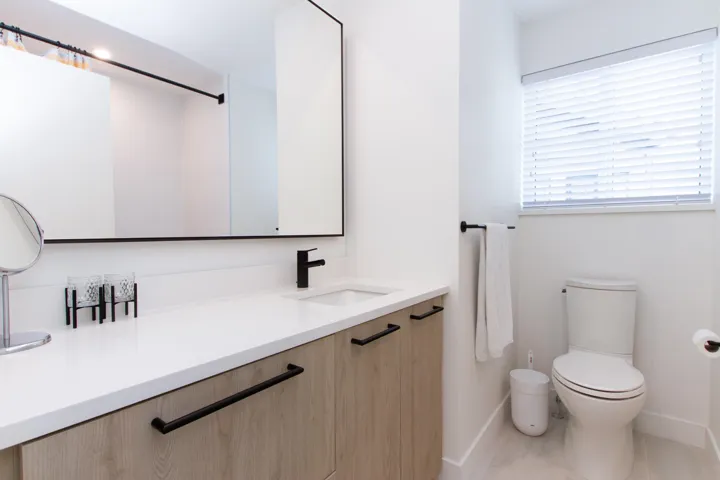Full bath with baseboards, toilet, and vanity