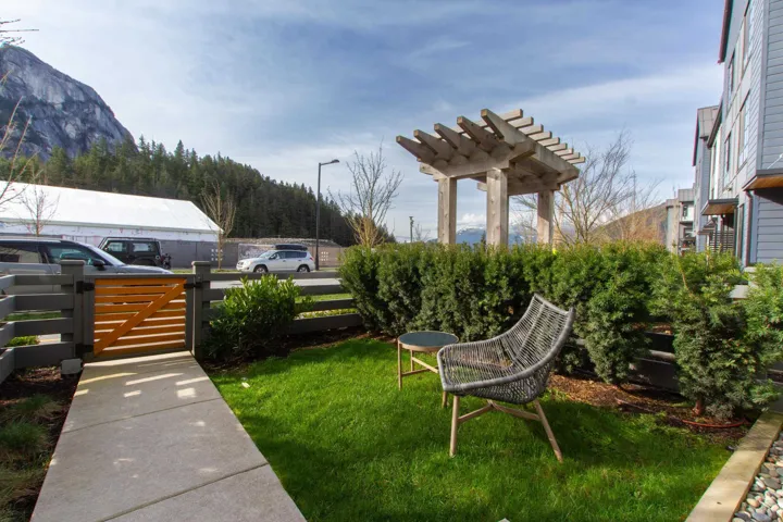 View of yard with a gate, fence, and a pergola