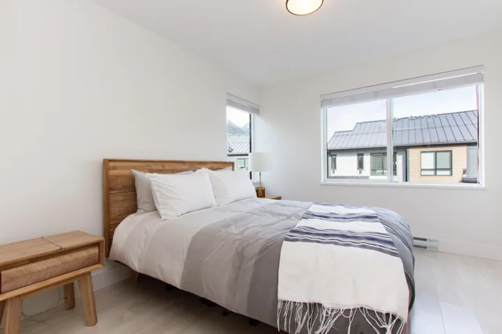 Bedroom with light wood-style flooring, baseboards, and baseboard heating