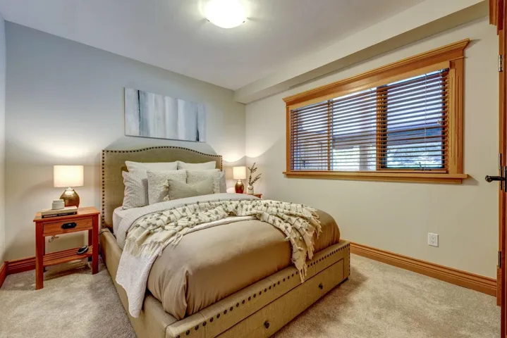 Carpeted bedroom featuring baseboards