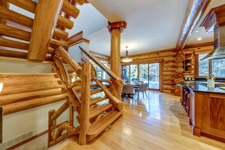 Staircase with rustic walls and wood finished floors