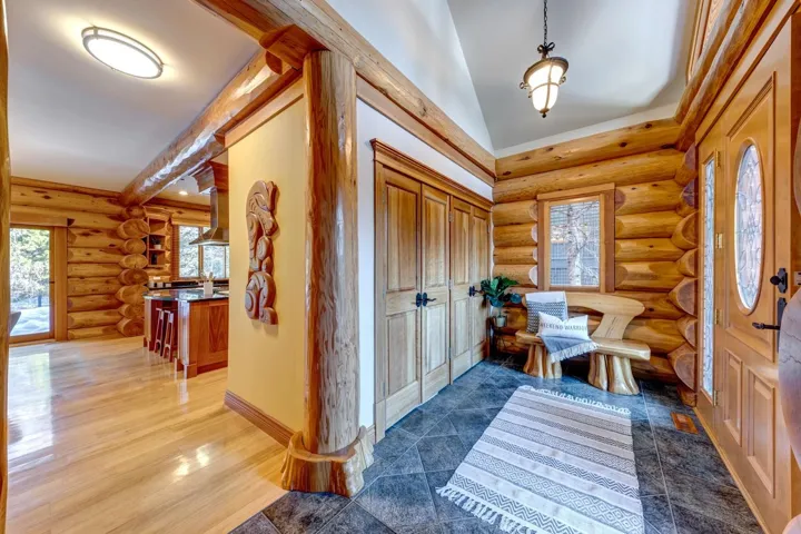Foyer entrance with rustic walls, healthy amount of natural light, and wood finished floors