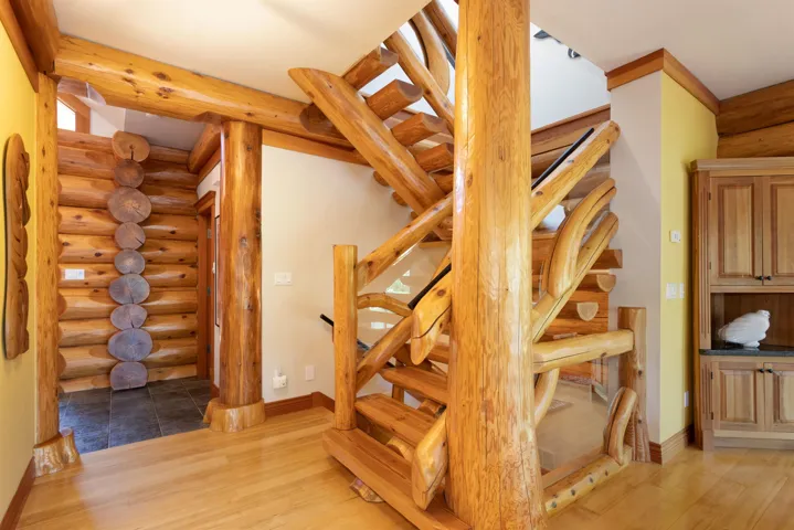 Stairs with rustic walls and wood finished floors