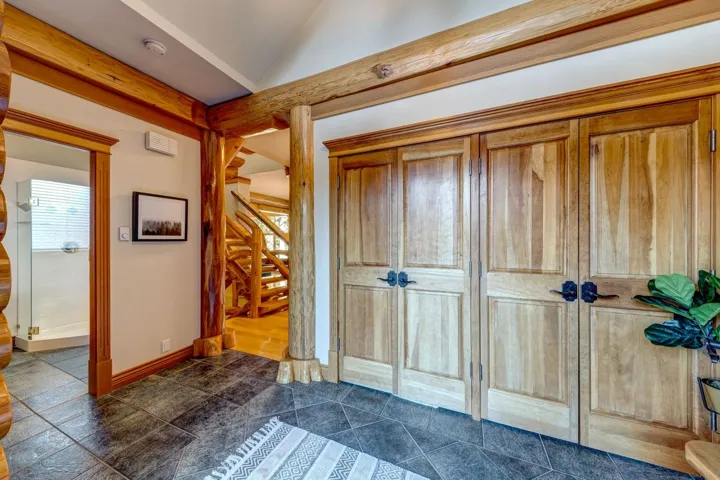 Entryway with stairway and vaulted ceiling