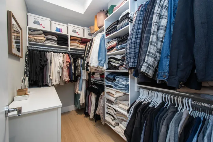 Walk in closet with wood finished floors