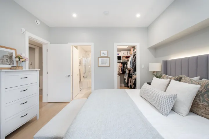Bedroom featuring a walk in closet, recessed lighting, a closet, ensuite bathroom, and light wood-style floors