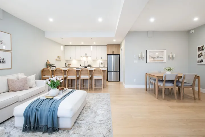 Living area with baseboards, recessed lighting, and light wood-style floors
