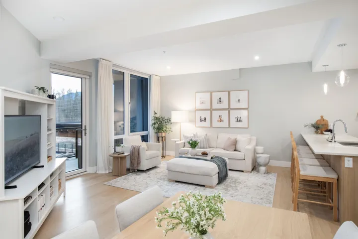 Living room featuring light wood-type flooring, baseboards, and recessed lighting
