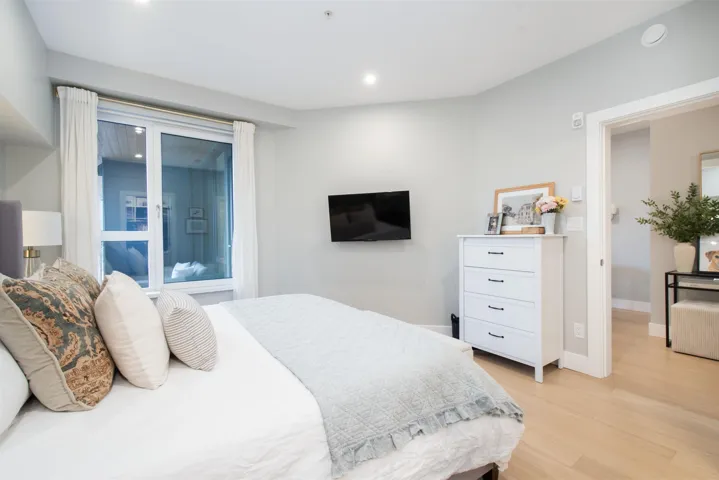 Bedroom with light wood finished floors, baseboards, and recessed lighting