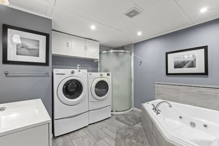 Laundry area with washer and dryer and recessed lighting