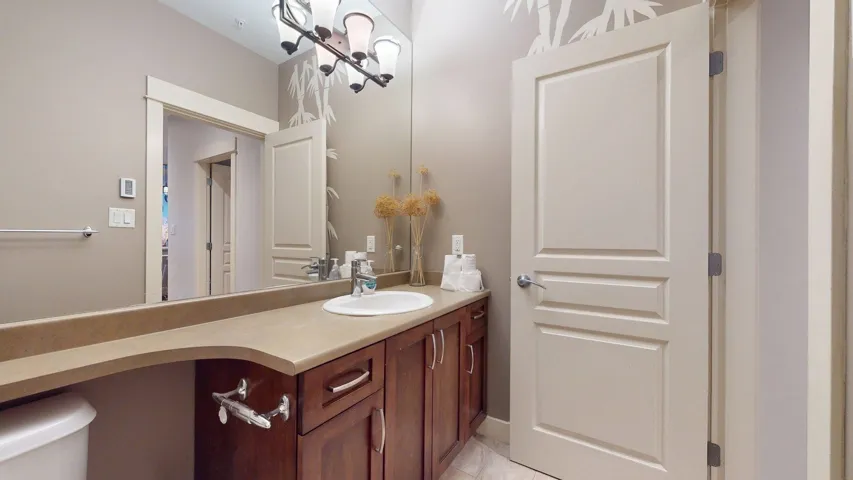 Half bath featuring vanity and light tile patterned floors