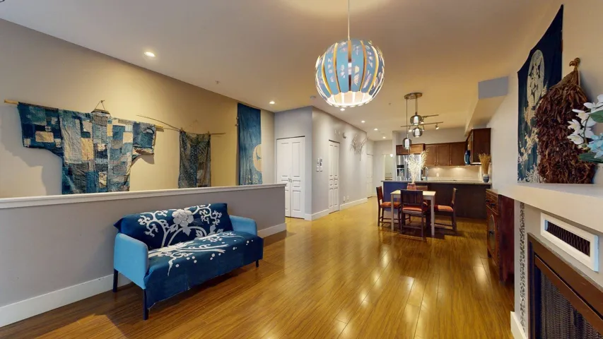 Living area with light wood-style floors and recessed lighting
