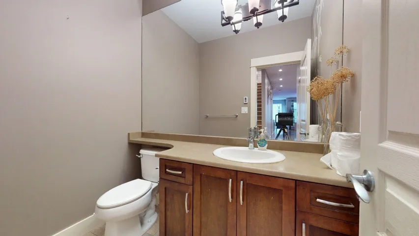 Half bath featuring vanity and light tile patterned floors
