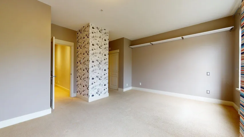 Unfurnished bedroom featuring light colored carpet and baseboards