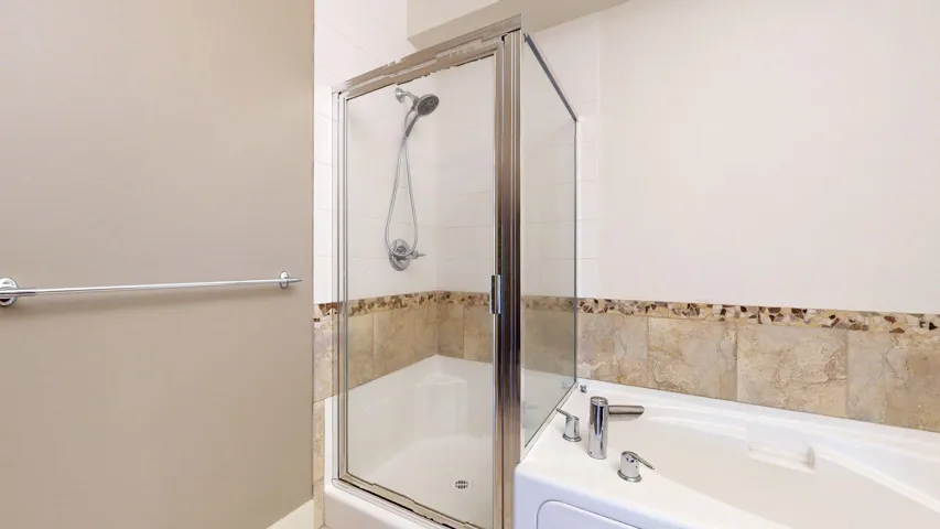 Full bath with a shower stall and a garden tub