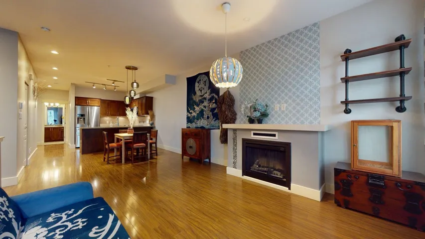 Living room with a fireplace and light wood-style floors
