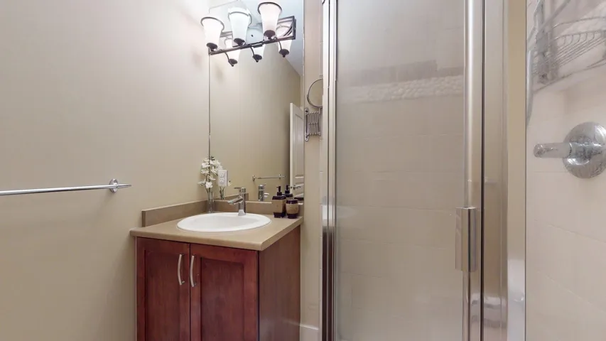 Bathroom with vanity and a stall shower