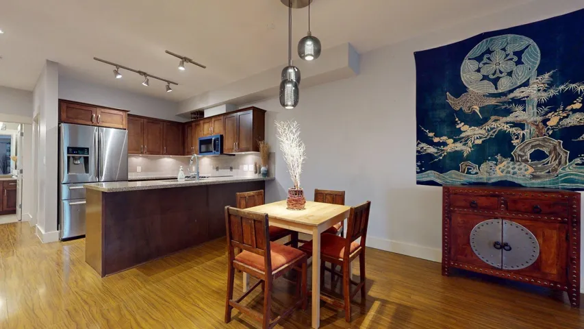 Dining area featuring light wood finished floors and rail lighting