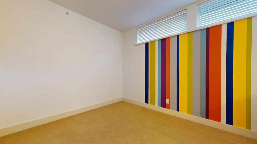 Carpeted empty room with baseboards