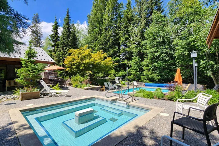 Community pool featuring a patio area and a hot tub