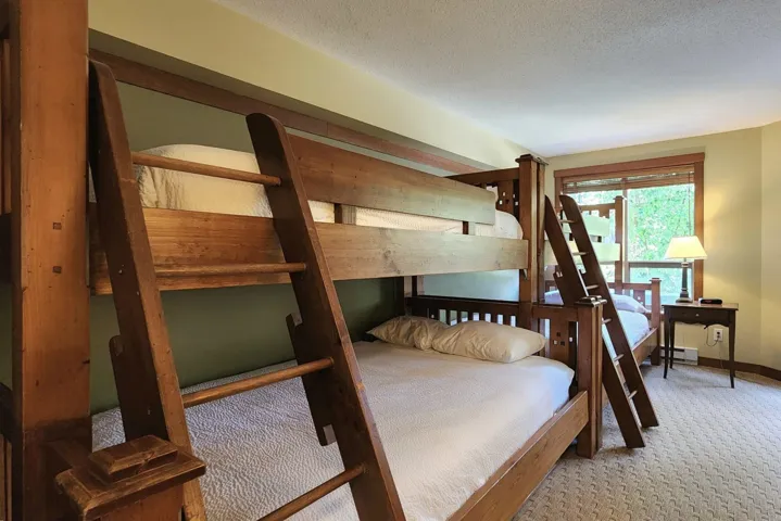 Bedroom with carpet, baseboard heating, and a textured ceiling