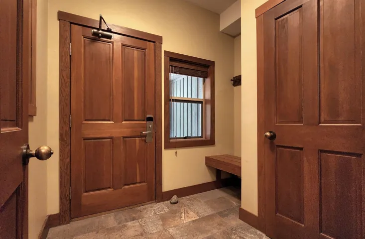 Mudroom featuring baseboards and stone finish floors