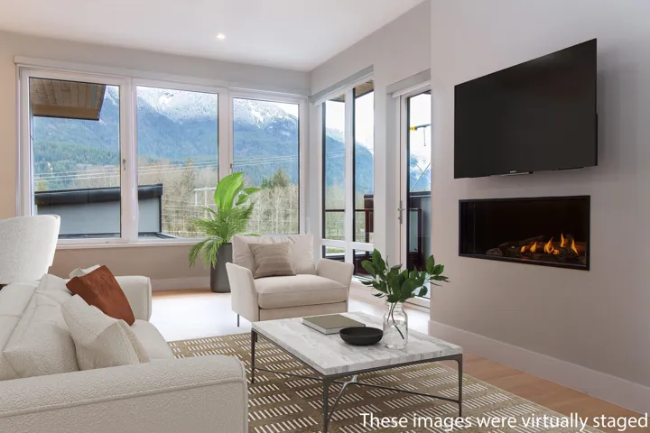 Living room with a warm lit gas fireplace, baseboards, light wood finished floors, and recessed lighting