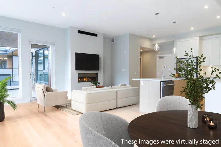 Living room with visible vents, recessed lighting, light wood-style floors, and a lit fireplace