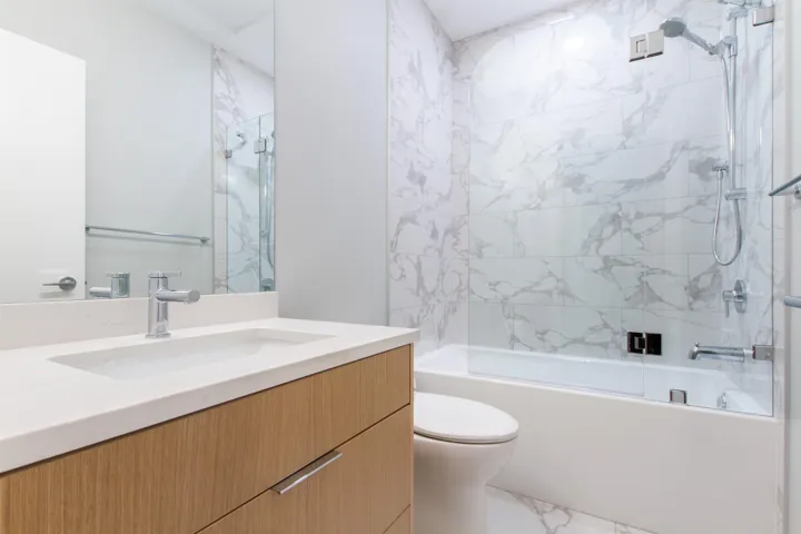 Bathroom with marble finish floor, toilet, shower / tub combination, and vanity