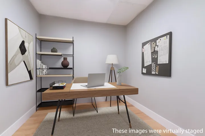 Staged Office with light wood-type flooring and baseboards