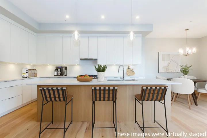 Kitchen with quartz countertops, modern cabinets, a sink, and white cabinetry