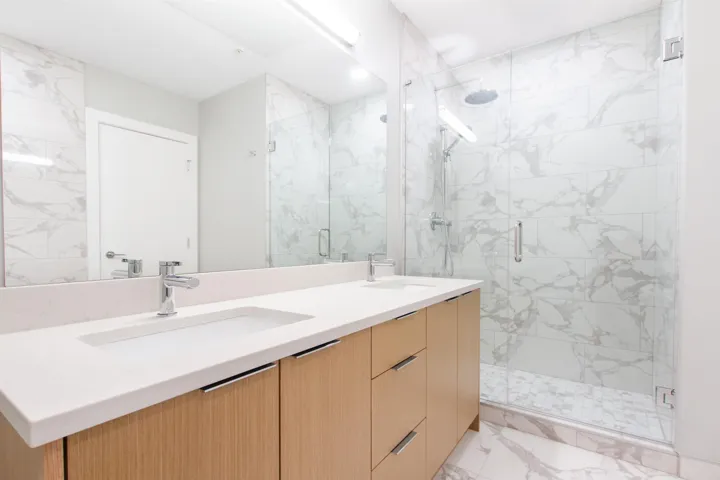 Primary Ensuite with Full bath with marble finish floor, a sink, and a stall shower