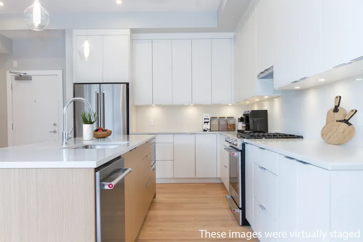 Kitchen featuring white cabinets, modern cabinets, a sink, premium appliances, and an island with sink